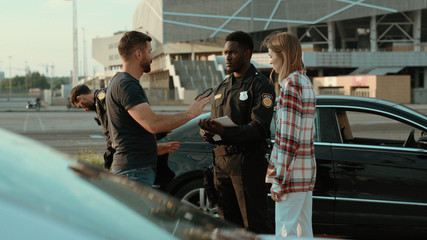 police officer with two men after a car accident