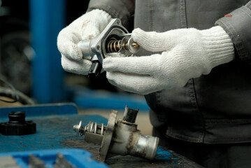 mechanic holding car parts